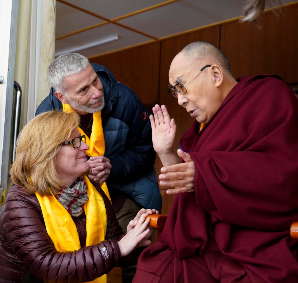 Enders and her husband with the Dalai Lama.