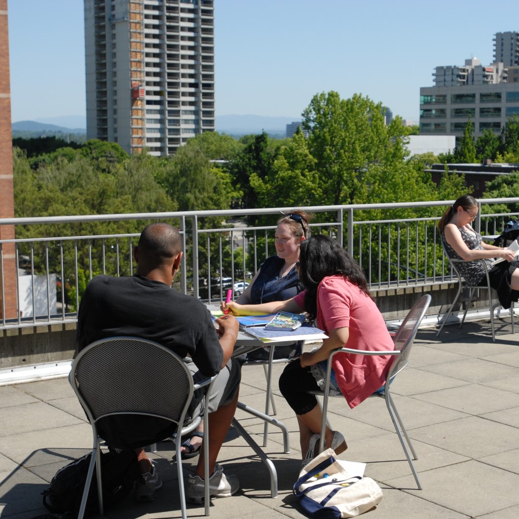 Student sitting on a Portland rooftop
